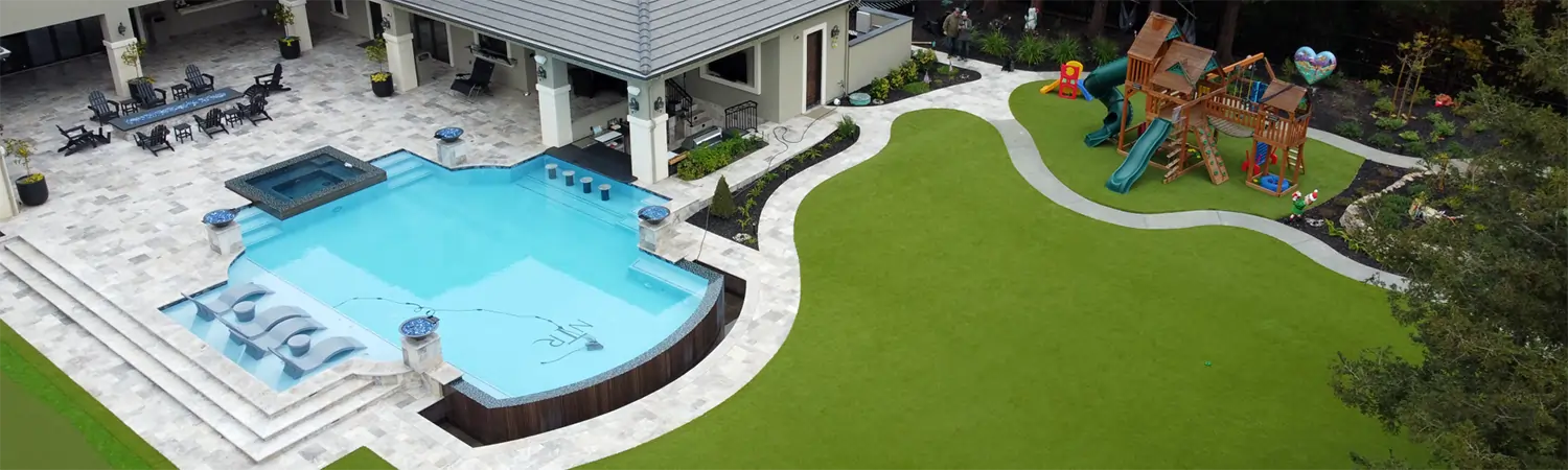 Artificial grass backyard pool area installed by SYNLawn